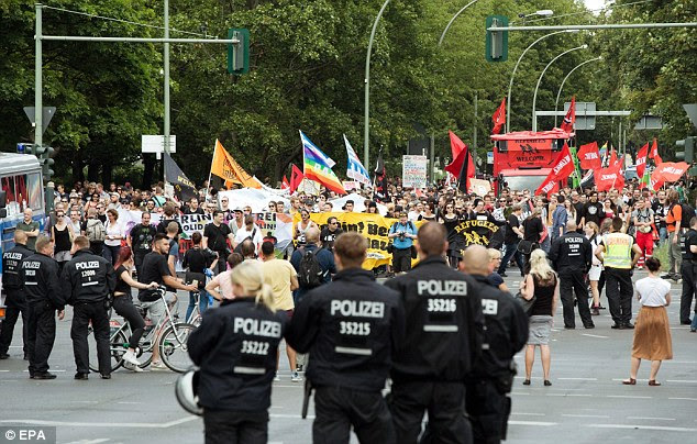 Police manned the streets of Germany, which is still on high alert following the attacks, as right-wing protesters met thousands of counter-demonstrators (pictured, Berlin)