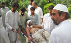 An injured victim is taken to hospital after a bombing on a police station in north-west Pakistan.