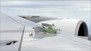 Damaged wing of Qantas jet, seen from window in flight