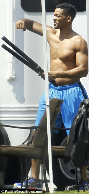 Check out those guns: Will Smith put his impressive muscles on display as he worked out topless on the set of his latest movie Focus