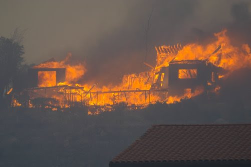pics of houses on fire. We believe this house caught fire when a flying ember hit a wooden deck.