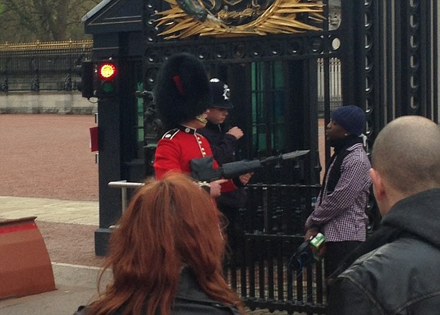 The guard, clad in the traditional red tunic and bearskin hat, strode 