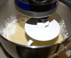 When liquid mixture is just warm, add yeast to 2 cups of the flour, mix with liquid.