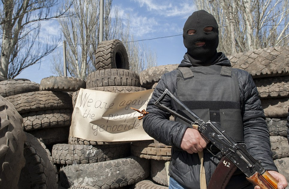Five people were killed in a gun battle in the easter Ukrainian city of Slaviansk, it has been reported. Pictured, a young soldier in front of an occupied building in Slaviansk.