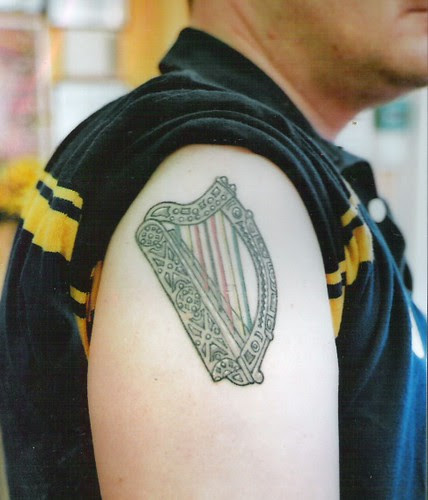 Irish harp with Zimbabwe colors in strings by dublin ireland tattoo artist