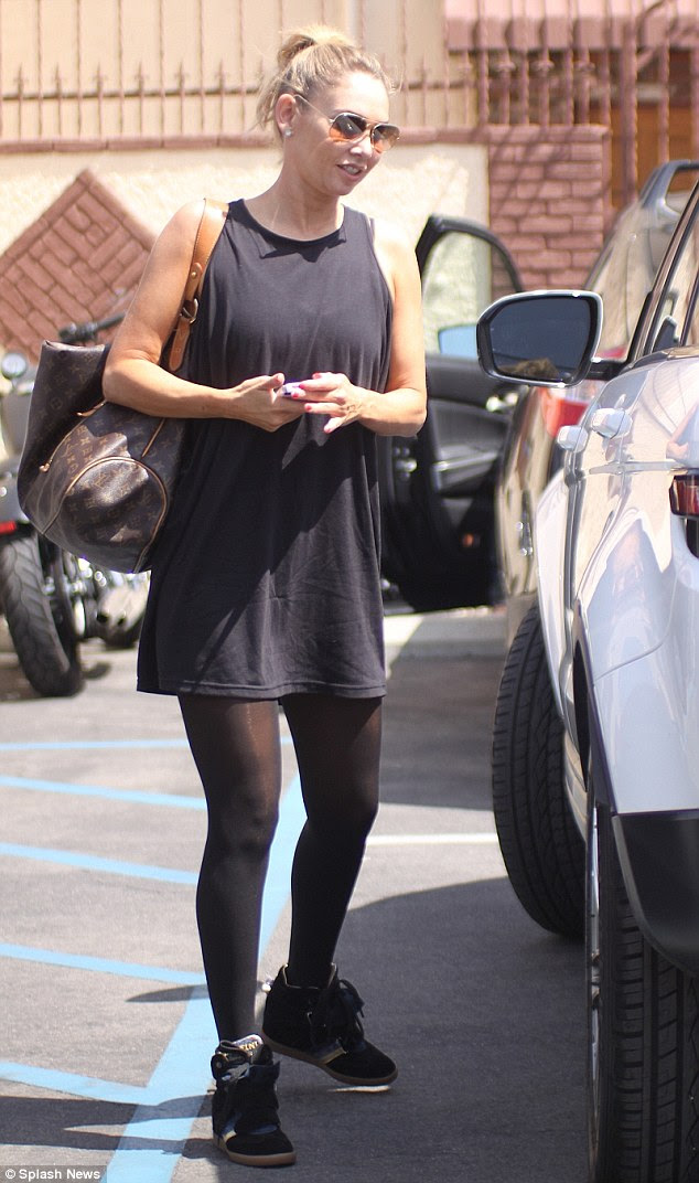 Cute outfit: The dancer showed off her toned physique in a loose-fitting short black dress paired with black stockings 
