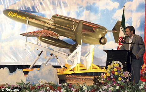 Posturing: Iranian President Mahmoud Ahmadinejad unveils the Karar - a long-range bomber drone capable of carrying four cruise missiles