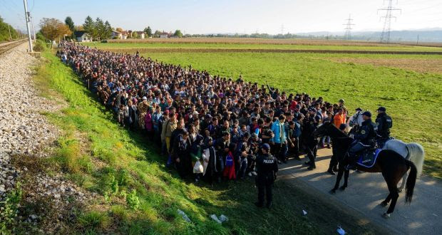 Police escort migrants and asylum seekers as they walk to a refugee centre after crossing the Croatian-Slovenian border near Rigonce on October 24th. Photograph: Jure Makovec/AFP/Getty Images