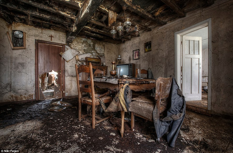 Remnants of family life: A table and chairs discovered inside what was once the dining room of this now dilapidated farmhouse in western Europe