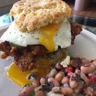 [Homemade] - Fried chicken biscuit sandwich with pan fried goat cheese medallion, homemade dill pickle chips, fried egg, and homemade bacon habanero jelly. (Cheddar chive biscuit also homemade!) Side of black eyed pea salad.