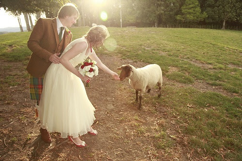 This picture is just too perfect with that sweet baby lamb. Perfect farm/barn wedding venue "accessory!" ... And can I just say how much I love the groom's kilt and the bride's red and white polka dot peep toe shoes?! Because they're awesome.