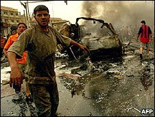 Fighfighters put out fires at the site of a car bomb attack in Baghdad in 2007