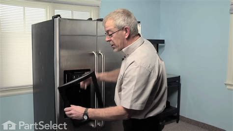 Pan under warm water run over it . Refrigerator Repair- Replacing the Ice Dispenser Door