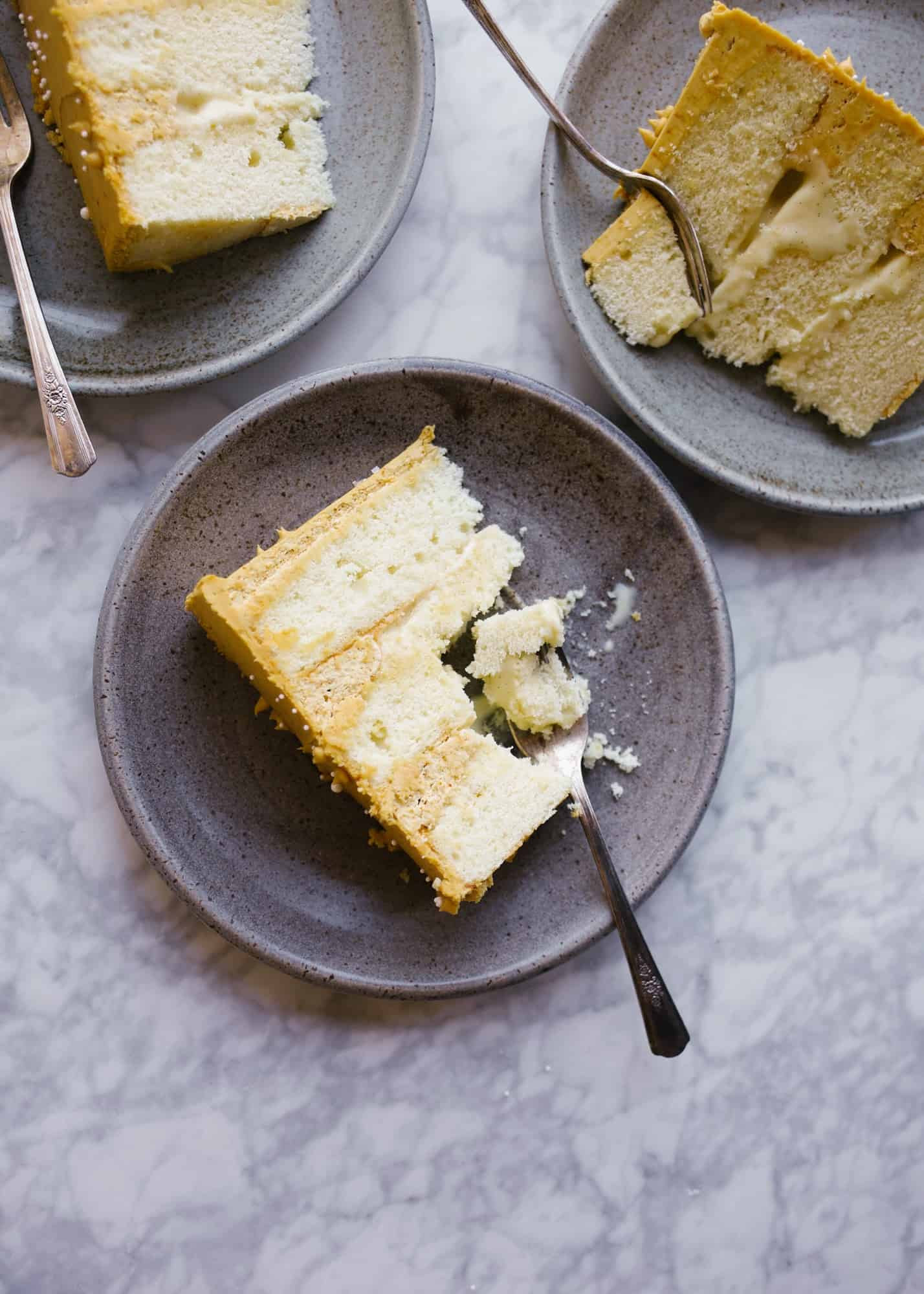 Creme Brûlée Cake by Wood and Spoon. This is a fluffy vanilla bean butter layer cake with a vanilla bean custard and a burnt sugar frosting. The cake has all the flavors of classic creme brûlée in layer cake form! Learn how to make this and assemble this stacked cake on thewoodandspoon.com