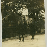 Woman and horse on bridge