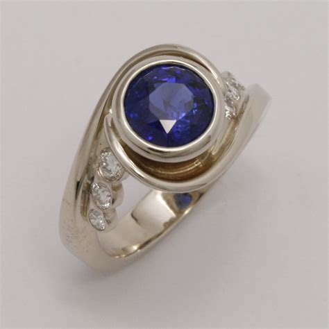 For fine jewelry, these gemstones make beautiful engagement rings and wedding bands. 18K White Gold Wrap Ring w/Blue Ceylon Sapphire & Diamonds