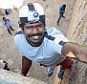 PIC FROM CATERS NEWS - (PICTURED: Jyoti at the top of the wall) - Meet the real-life Spiderman - who effortlessly scales buildings using his bear hands. Jyoti Raju has become famous in his native India thanks to his incredible talents. He regularly wows tourists at a fort near his home Chitradurga by running and scaling the towering relic in a matter of seconds. SEE CATERS COPY.