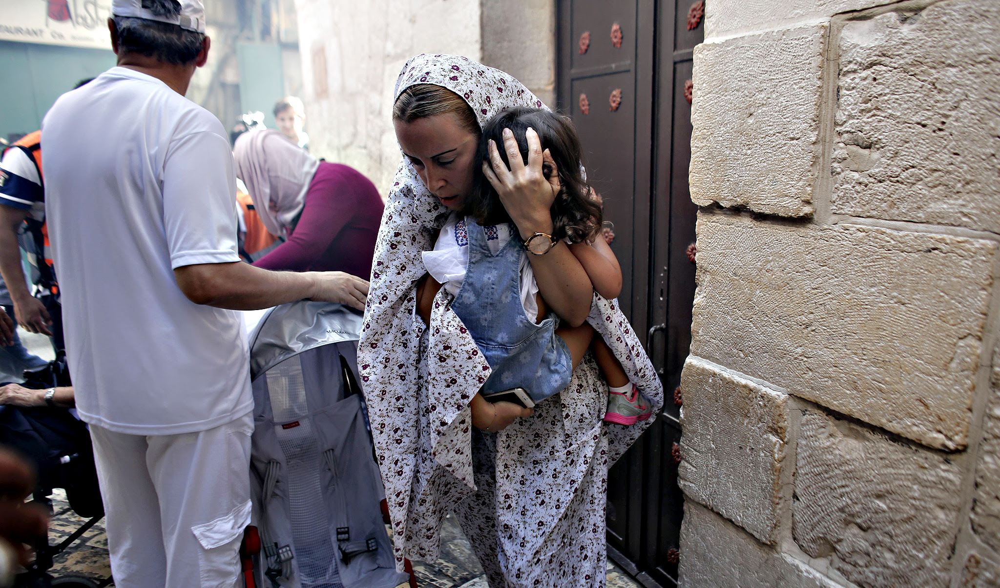 Turkish tourists are seen trying to take shelter during clashes between Palestinians protesters and Israeli police near the entrance of al-Aqsa mosque compound in Jerusalems old city on Monday. New clashes broke out between Palestinians and Israeli police who stormed Jerusalem's flashpoint Al-Aqsa mosque compound, as an expected increase in Jewish visitors to the site over the Sukkot holiday boosted tensions.