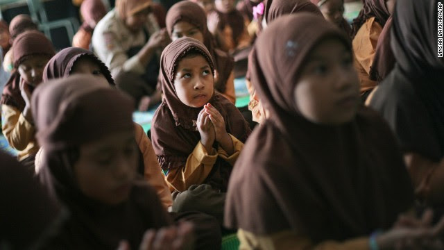 Elementary school students pray for the missing passengers during class in Medan, Indonesia, on March 15.