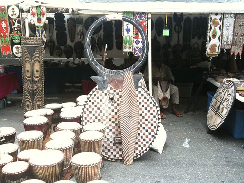 An artist and vendor at work, at right @ Harlem Book Fair