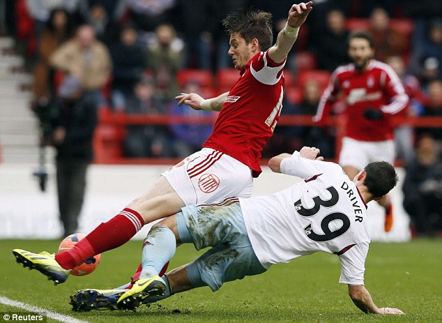 Passion of the Cup: West Ham's Callum Driver (right) goes in hard on Nottingham Forest's Greg Halford