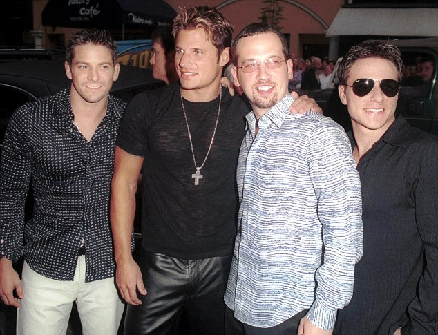 The heat is on again! Nick (second from left) is reuniting with his 98 Degrees bandmates Jeff Timmons, Justin Jeffre and Drew Lachey pictured here in 2001