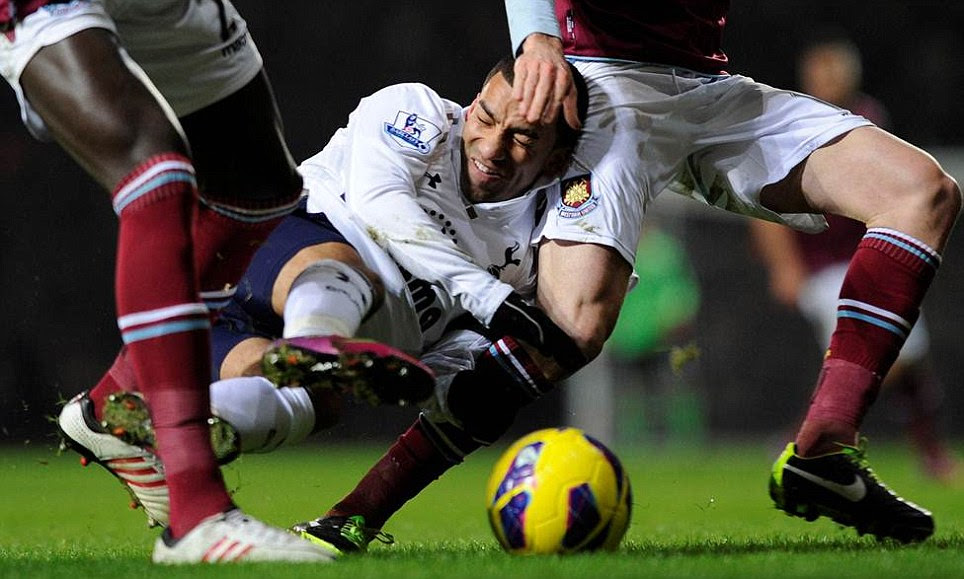 Taking a tumble: Aaron Lennon is squashed between two West ham players and hits the turf during the Monday night clash in February which Spurs won 3-2
