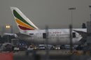 General view of the Air Ethiopian Boeing 787 Dreamliner 'Queen of Sheba' aeroplane, on the runway near Terminal 3, at Heathrow Airport, London, Friday July 12, 2013. Two Boeing 787 Dreamliner planes ran into trouble in England on Friday, with a fire on one temporarily shutting down Heathrow Airport and an unspecified technical issue forcing another to turn back to Manchester Airport. The incidents are unwelcome news for Chicago-based Boeing Co., whose Dreamliners were cleared to fly again in April after a four-month grounding due to concerns about overheating batteries. The fire at Heathrow involved an empty Ethiopian Airlines plane, which was parked at a remote stand of the airport after arriving at the airport. British police said the fire is being treated as unexplained, and that there were no passengers on board at the time of the fire. (AP Photo/Sang Tan)