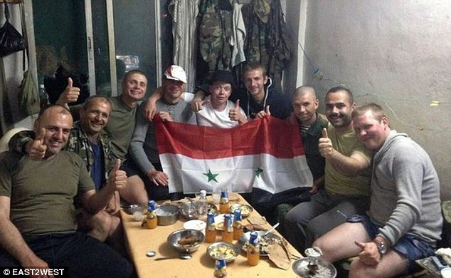 Troops give a thumbs up and hold a Syrian flag in this picture taken in Tartus and posted online by Evgeny Dolgarev on May 9