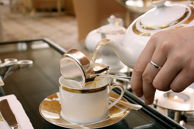 Lovely waitresses pouring tea for you