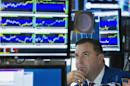 A trader looks up at screen as he works on floor of New York Stock Exchange shortly before closing of the market in New York