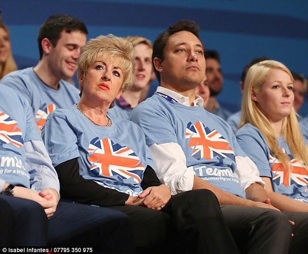 Mark Clarke is pictured sat next to former deputy Conservative party chairman Emma Pidding (left)