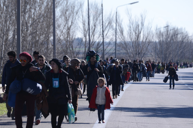 Migrants make their way to reach the borderline to Macedonia, near the northern Greek village of Idomeni, on Sunday, Feb. 21, 2016. Macedonia has closed its ...