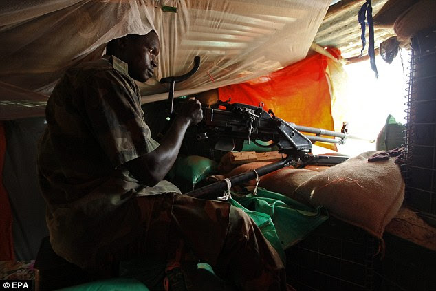 An African Union soldier has his gun ready at a military base in Afgoye district, some 30km northwest of the capital Mogadishu, Somalia