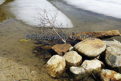 melting ice along the edge of the lake 