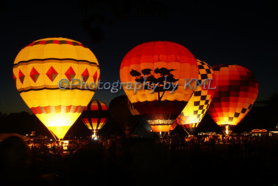 hot air balloons glowing at night