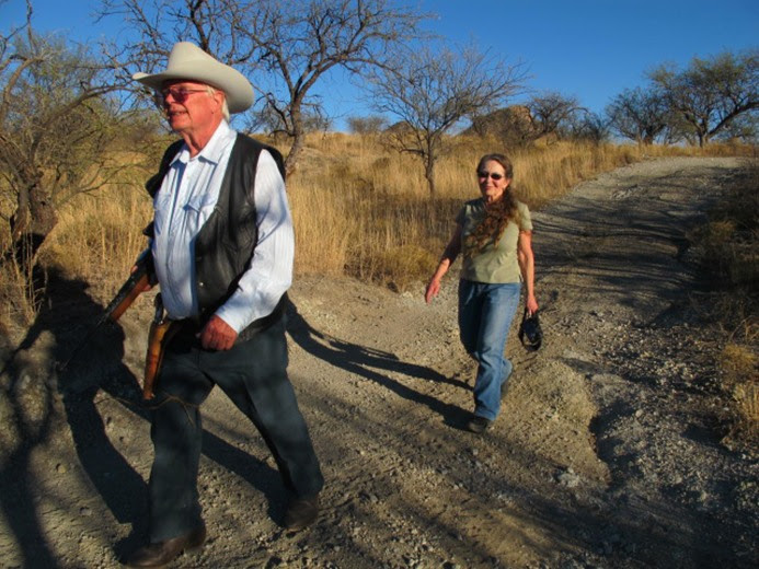 Image: Jim and Sue Chilton walk near the U.S. and Mexico border at the Chilton's ranch.