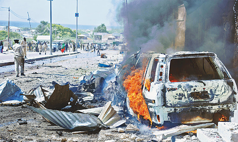 Mogadishu: A car burns following a blast near the heavily fortified gates of the airport in Mogadishu on Wednesday.—AFP