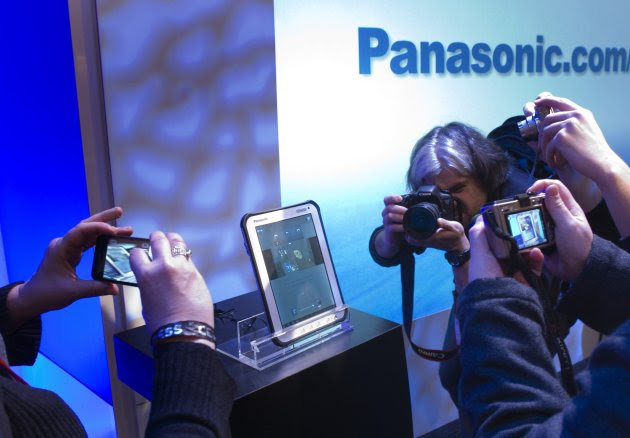 Journalists take photos of a Panasonic Toughpad after a Panasonic news conference for the 2012 International Consumer Electronics Show (CES) in Las Vegas