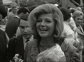 Crowds of press are held back as Hollywood actress Rita Hayworth steps off aircraft at Vienna airport; May 66