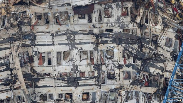 A detail of the previously submerged side of the Costa Concordia is seen after it was lifted upright, on the Tuscan Island of Giglio, Italy, Tuesday, 17 September, 2013.