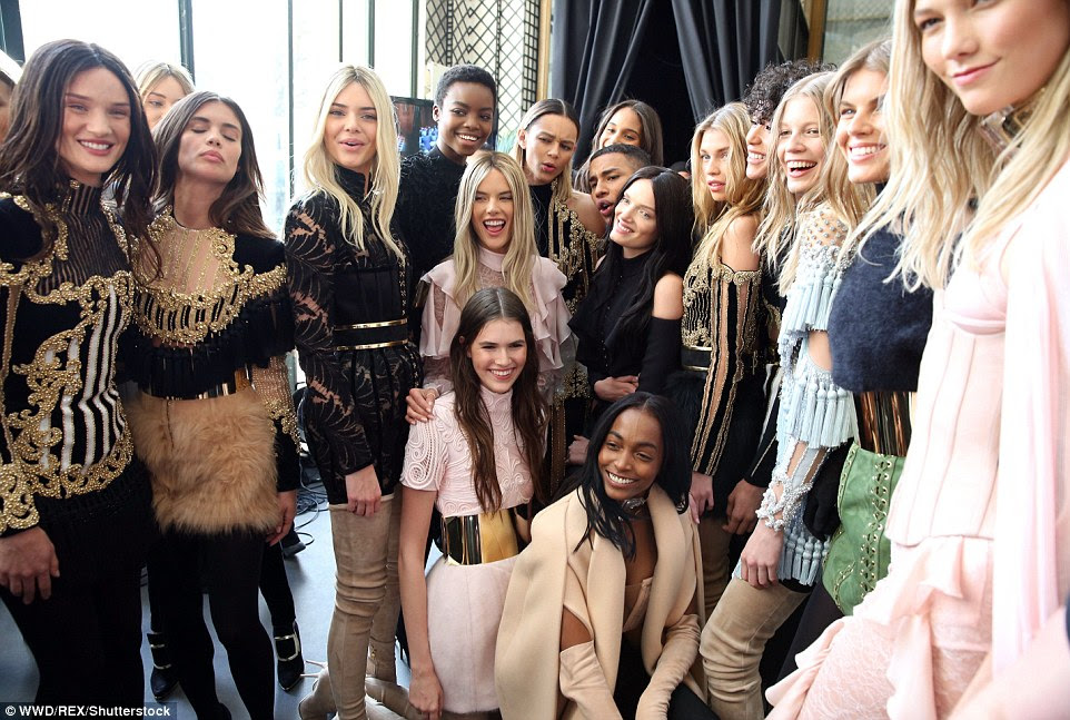 All together now: The models all posed for a smiley shot backstage along with the designer himself, Olivier Rousteing (centre)