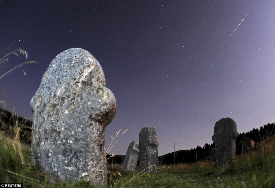 A meteor streaks over the sky during the Perseid meteor shower at the Maculje archaeological site near Novi Travnik in central Bosnia on August 12, 2014