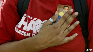 Seguidora de Chávez sostiene una fotogragía del fallecido presidente entre las manos