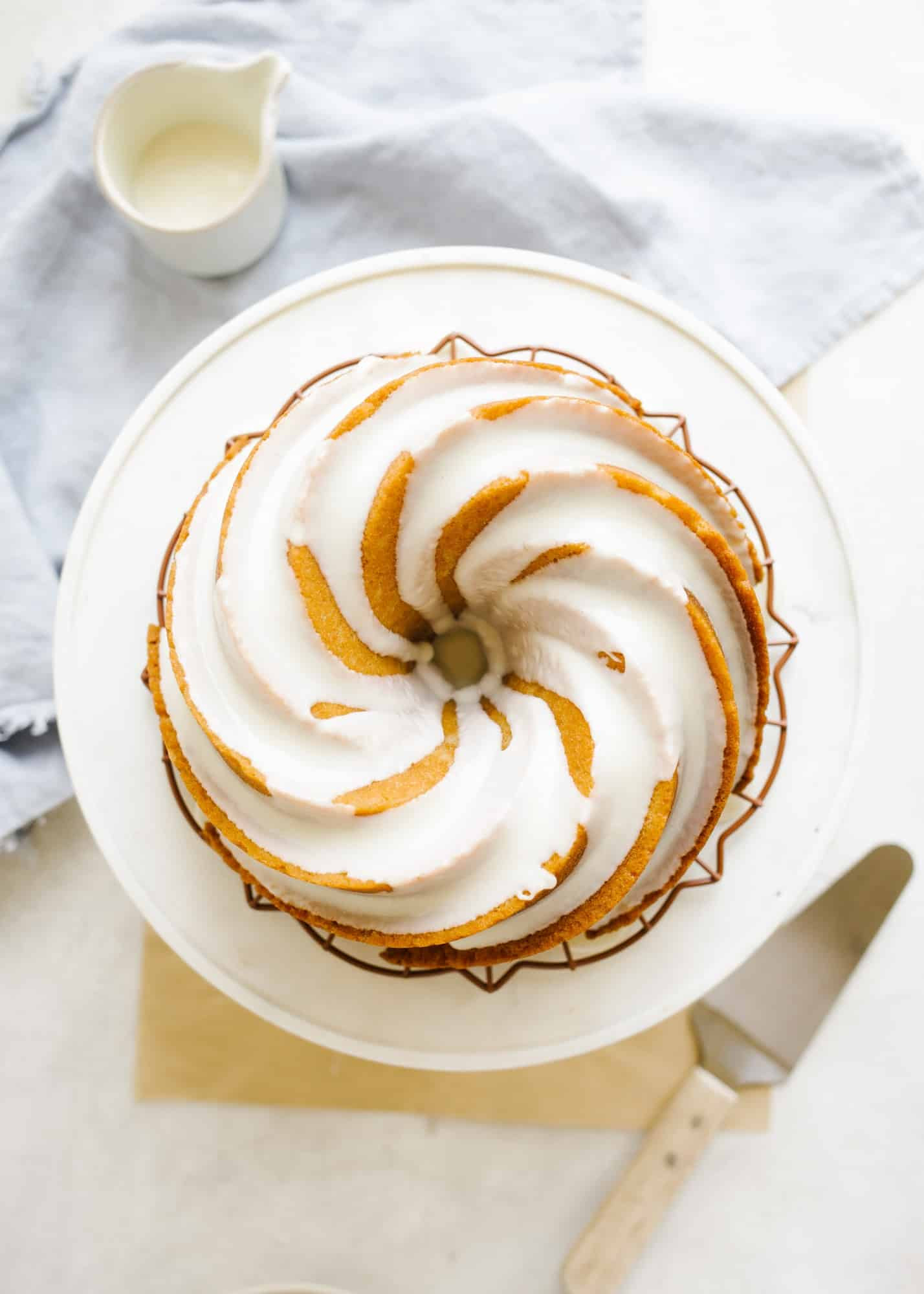 Bourbon Bundt Cake by Kate Wood. This is a boozy and moist bundt cake make with Kentucky whiskey and a bourbon glaze. The cake is fluffy and tall and serves as a great breakfast or brunch or dessert item! It comes together in one bowl and can be made in advance. Learn more about this fall simple cake on thewoodandspoon.com