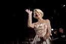 English actress Helen Mirren waves as she arrives at the Tokyo International Film Festival in Tokyo