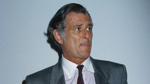 Frank Deford in 1991, holding a dummy copy of the final edition of The National Sports Daily, which he edited and published. It