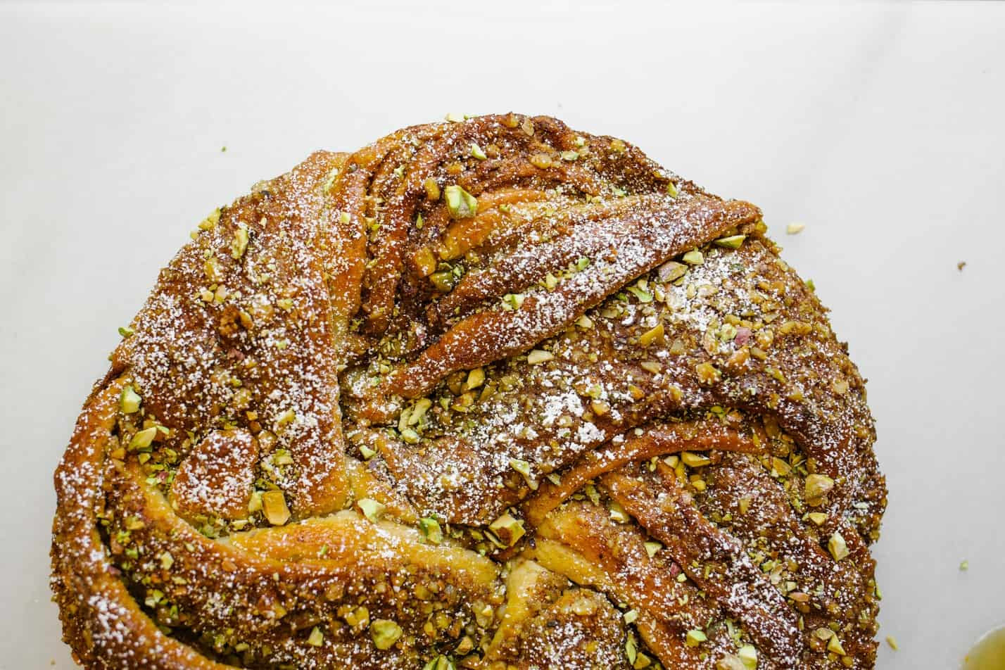 Braided Baklava Brioche by Wood and Spoon. This is a wreath loaf inspired by the meditteranean dessert filled with cinnamon, honey, walnuts, and pistachios. The yeast dough is sweetened with brown sugar and honey syrup and the crunchy nut filling adds flavor and texture. Heat up warm slices as a dessert or for breakfast. Learn more and how to braid the bread on thewoodandspoon.com