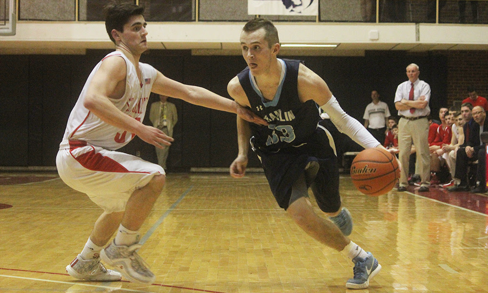 Franklin senior Tim Prunier dribbles past a St. John;s defender in the second half. (Ryan Lanigan/HockomockSports.com)