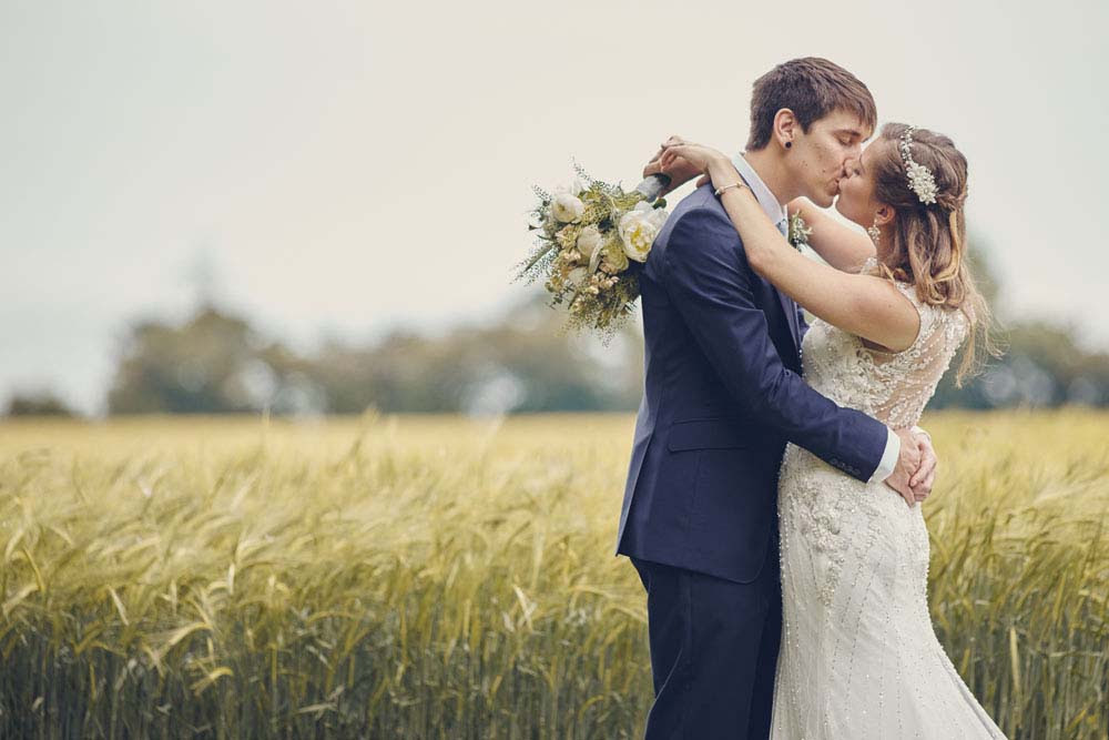 Wedding Kiss with field in Suffolk - www.helloromance.co.uk
